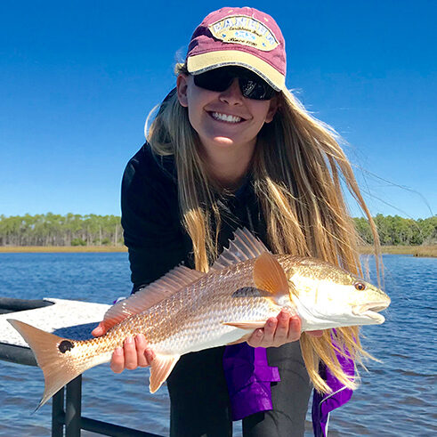 Customer Holding Red Fish